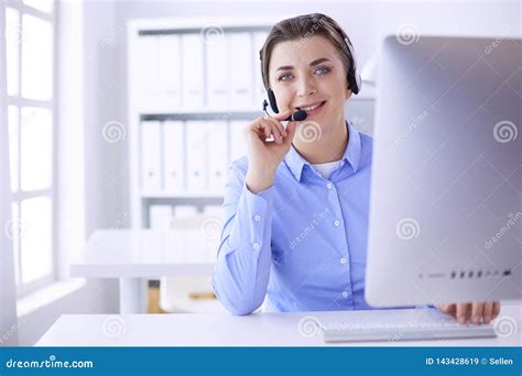 Serious Pretty Young Woman Working As Support Phone Operator With