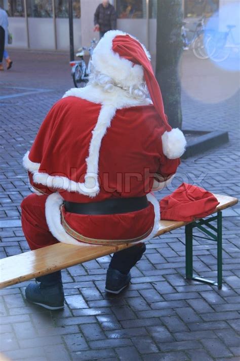 Santa Claus Sits On The Wooden Bench Stock Image Colourbox