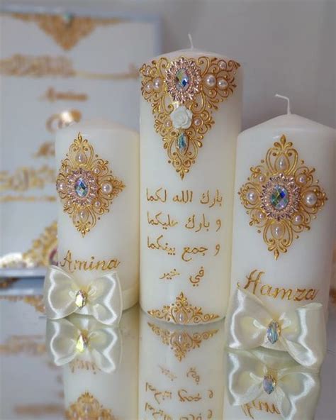 Three White Candles With Gold Designs And Bows