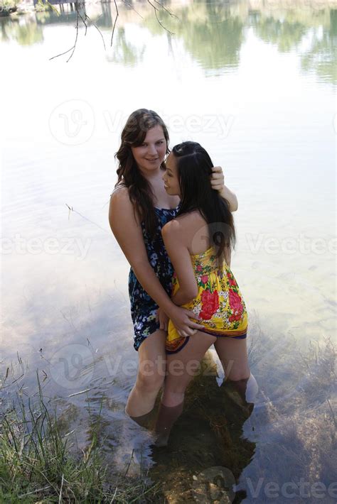 Two Women In River Holding Dress Hems 42552800 Stock Photo at Vecteezy