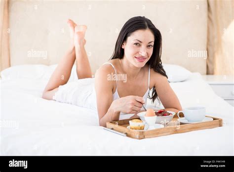 Pretty Brunette Eating Her Breakfast On Bed Stock Photo Alamy