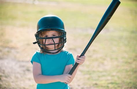 Premium Photo | Child playing baseball batter in youth league getting a ...