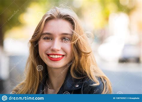 Beautiful Woman Walks Through City Streets Between Building Stock Image