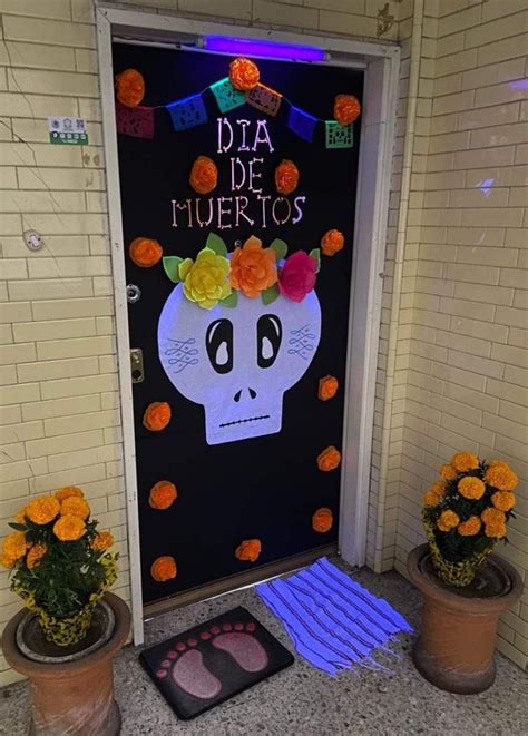 A Door Decorated With Flowers And An Image Of A Skeleton On It S Face