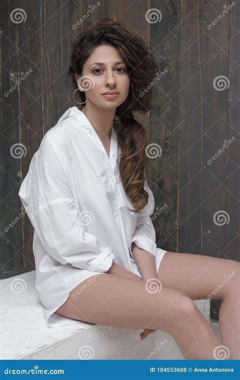 Portrait Of Brunette Beautiful Girl Sitting In White Shirt Stock Photo Image Of Brunette