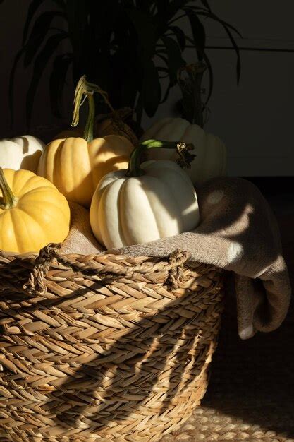 Premium Photo Cozy Still Life With Pumpkins Lying In A Wicker Basket