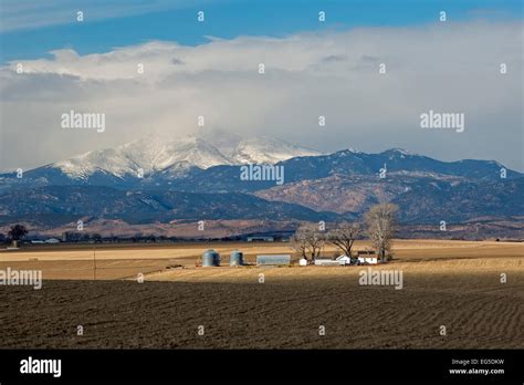 Greeley, Colorado - A farm below the snow-capped Rocky Mountains Stock ...