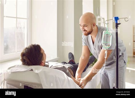 Smiling Medical Nurse Gives Intravenous Iv Line Vitamin Infusion To