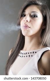 Elegant Brunette Woman Smoking Cigarette On Stock Photo