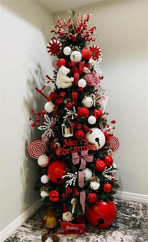 A Christmas Tree Decorated With Red And White Ornaments