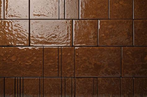 A Brown Tile Wall With A Water Droplet On It Premium Ai Generated Image