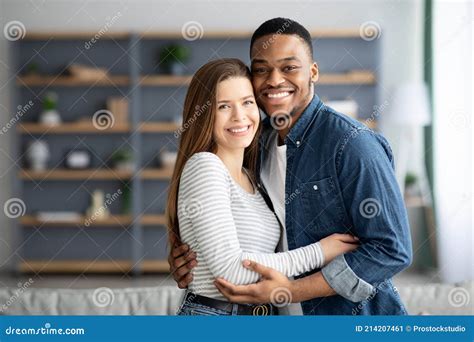 Portrait Of Romantic Interracial Couple Embracing And Smiling At Camera Stock Image Image Of