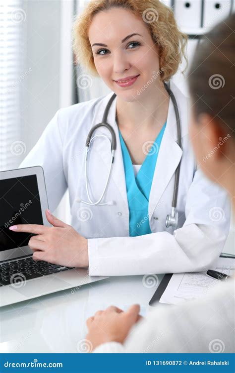 Happy Blonde Female Doctor And Patient Discussing Medical Examination Results Medicine