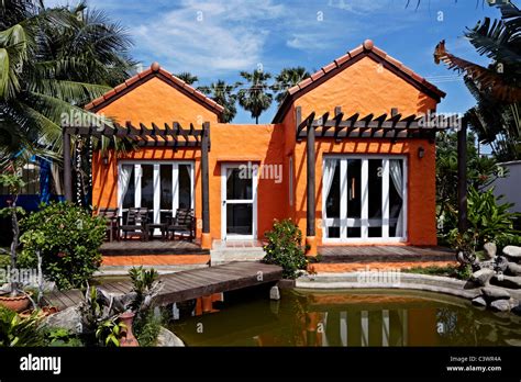 Orange paint house exterior. Thailand S. E. Asia Stock Photo - Alamy