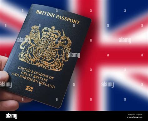 Hand holding a British Passport in front of the Union Jack. Travel ...