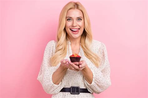 Photo Portrait Of Lovely Blonde Woman Hold Cupcake Lick Teeth Excited Want Dressed Stylish White