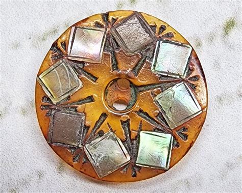 A Circular Metal Object Sitting On Top Of A White Surface