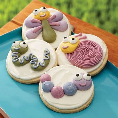 Four Decorated Cookies Sitting On Top Of A Blue Plate