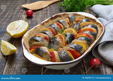 Baked Fish With Vegetables Pieces Of Herring Onions Tomato Lemon