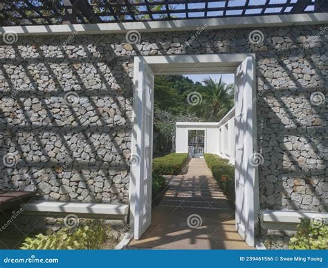 Square Pathway Along Stone And Wire Fence Of Ressidential Building With