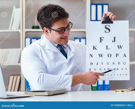 Doctor Optician With Letter Chart Conducting An Eye Test Check Stock