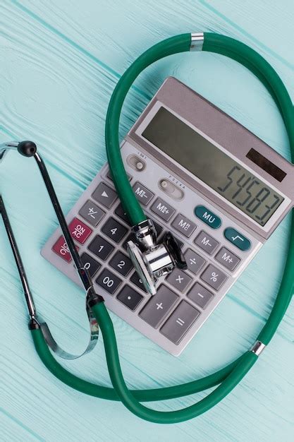 Premium Photo Green Stethoscope On Calculator Concept Cost Of