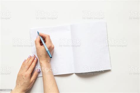 Female Hands Write In A Notebook In A Cage On A White Background Blank