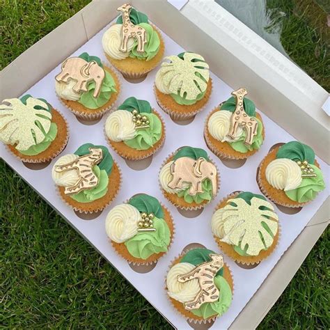 Twelve Cupcakes With Green And Yellow Frosting In A Box On The Grass