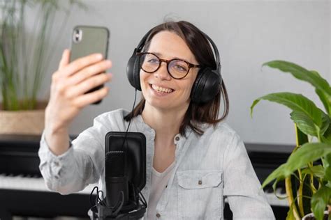 Premium Photo Portrait Of Smiling Young Woman Using Mobile Phone