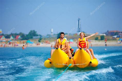 Happy people having fun on banana boat — Stock Photo © olesiabilkei #30731131