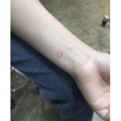 Minimalistic Red Heart Tattoo Located On The Wrist