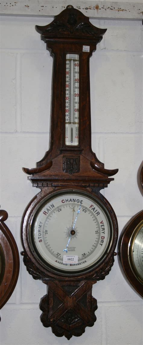 A Victorian Oak Cased Wheel Aneroid Barometer With Mercury Thermometer