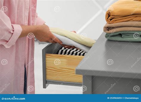 Woman Putting Clean Clothes Into Drawer At Home Closeup Stock Image