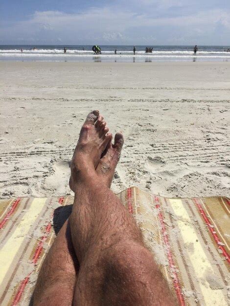 Premium Photo Low Section Of Person On Beach