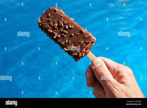 Popsicle Against A Swimming Pool On A Hot Day Stock Photo Alamy