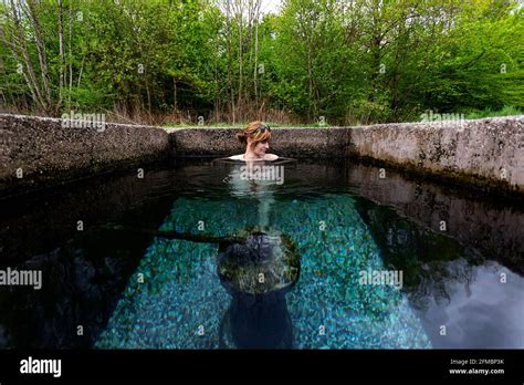 Woman Relaxing In Outdoor Hot Spring Stock Photo Alamy