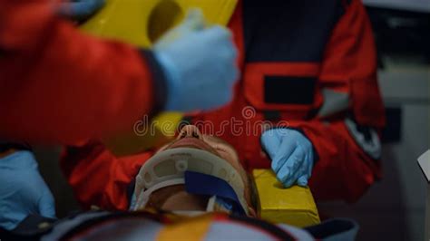 Paramedics Performing First Aid Help Of Patient In Emergency Car Stock