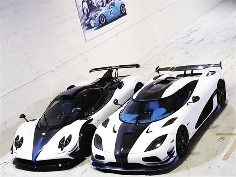 Two White And Black Sports Cars Parked Next To Each Other