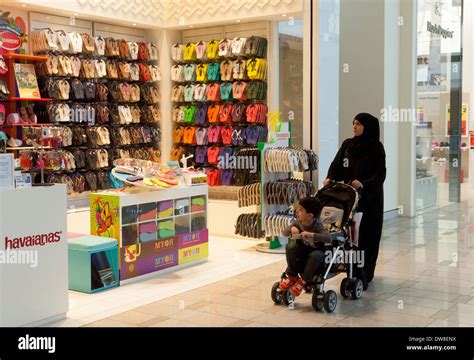 Muslim woman in a burka shopping with her child, Dubai Mall, Dubai, UAE ...