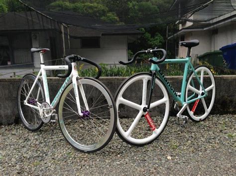 Two Bikes Parked Next To Each Other On Gravel