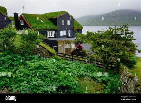 Typical Faroese Village With Traditional Grass Roof House And Stunning Fjord Landscape On