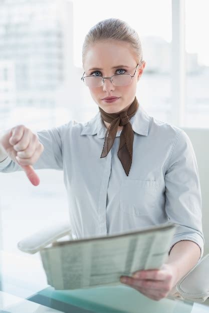 Premium Photo Blonde Serious Businesswoman Holding Newspaper And