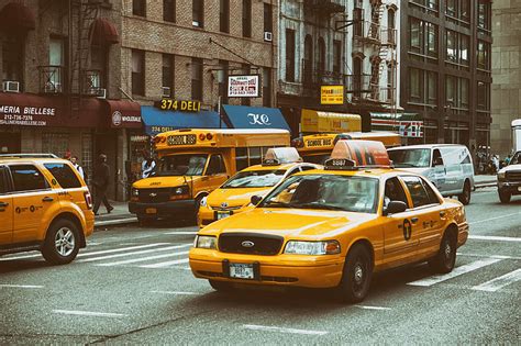 Royalty-Free photo: Yellow taxis and buses on the streets on Manhattan ...
