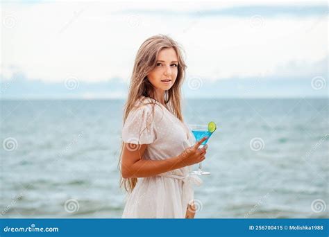 Woman With Cocktail By The Sea Looking At Camera Stock Image Image Of Holiday Alone 256700415