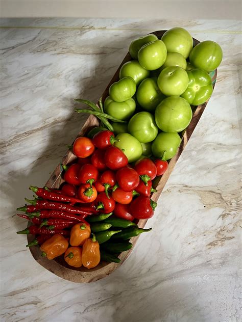Tomatillos and peppers have been growing like crazy this year : r