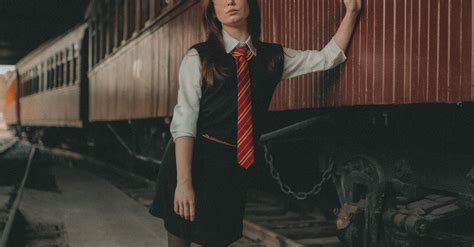 Woman in Vest and Tie Standing by Train Wagons · Free Stock Photo