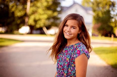 Premium Photo Portrait Of Smiling Girl Standing Outdoors