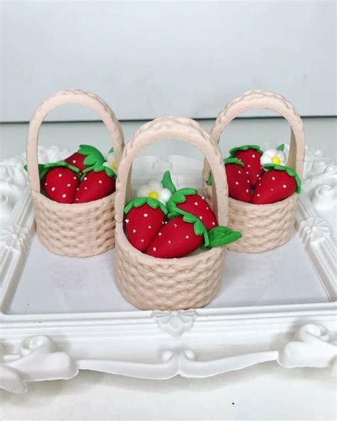 Three Baskets With Strawberries In Them Sitting On A White Tray Next To