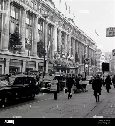 1950s, historical, Christmas decorations on the Selfridges department store on a busy Oxford ...