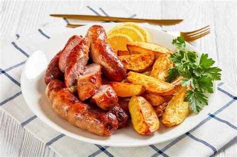 Premium Photo | Fried sausages on a plate with potatoes